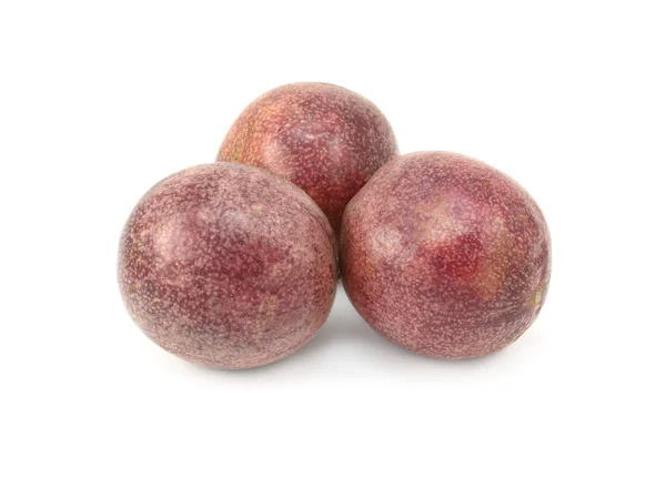 Three whole passion fruits with speckled purple skins — Stock Photo, Image
