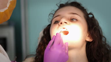 Diş hekimi profesyonel diş diş ofisinde Bayan genç hasta temizlik yapma