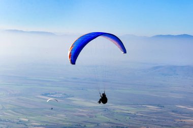 Mavi gökyüzü arka plan üzerinde uçan paraşütler 