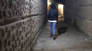 woman model walking in dark alley at night, narrow dirty corner, street in the old town clipart