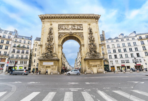 Paris, France - 05 May, 2017: Porte Saint-Denis looking down Rue Saint-Denis. The triumphal arch built in 1672 honors Louis the Great and replaced a medieval gate of the Wall of Charles V.