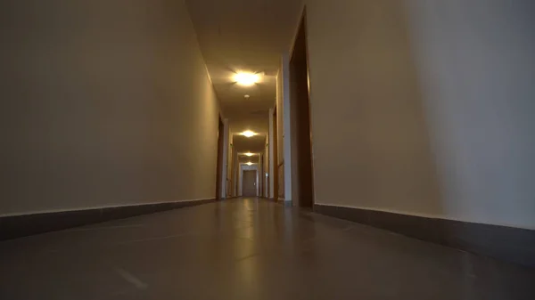Moving camera, walk in Hotel corridor, point of view. POV. Walking through hotel corridor. Interior gimbal shot. First person view
