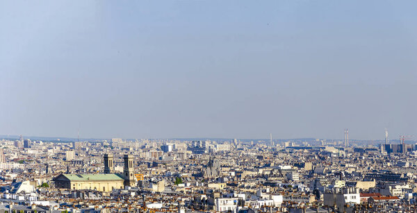 Aerial panoramic view over rooftops of Eglise Saint Vincent de Paul cathedral in Paris, France seen from Monmartre hill