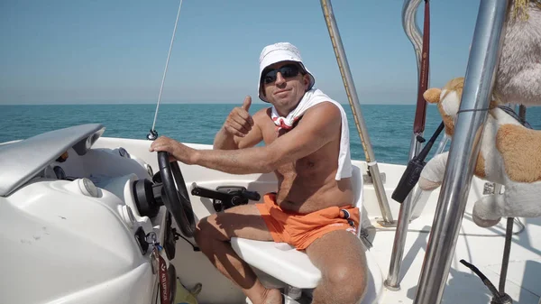 Hand of captain on steering wheel of motor boat on para-sail adrenaline tour in Durres, Albania