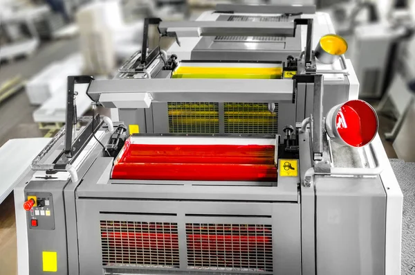 Press printing (printshop) - Offset machine detail. Magenta and yellow units