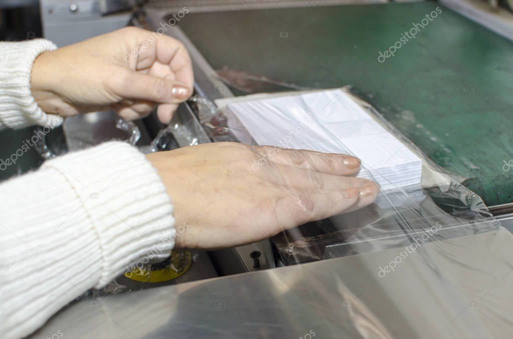 Hands on book foil packaging laminator in print plant production