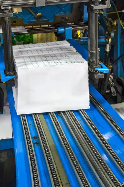 Print shop (press printing) - Finishing line. Post press finishing line machine: cutting, trimming, paperback and binding