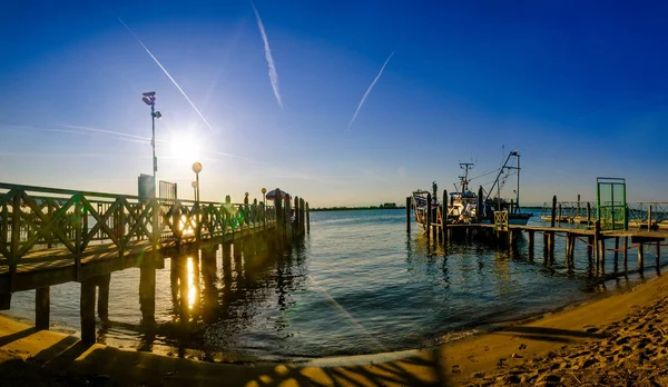 Late afternoon at a Venice lagoon with an old wooden landing pier, Lido di Jesolo, Italy