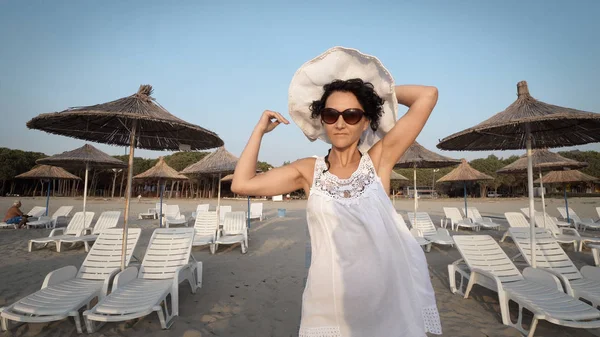 Mulher Vestido Branco Posando Com Chapéu Enquanto Caminhava Praia Vazia — Fotografia de Stock