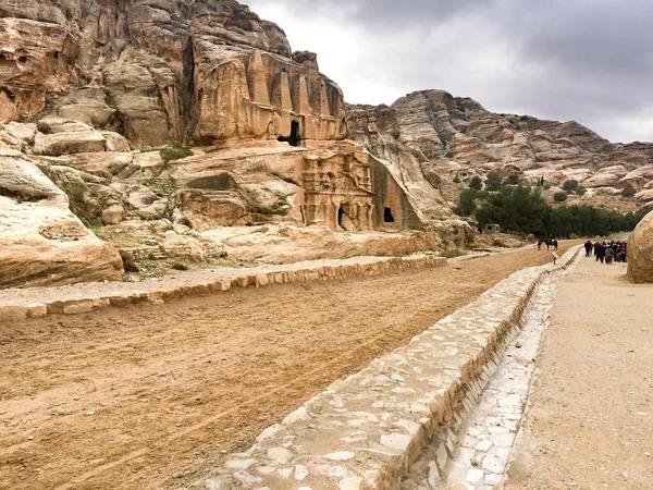 Dwellings carved in stone cliffs of ancient Petra, Jordan