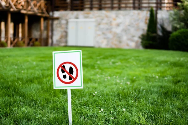 No Walking Sign in a Park Grass Lawn