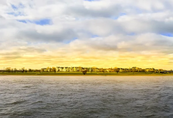 View along the Rhine River houses at sunset, Dusseldorf, Germany