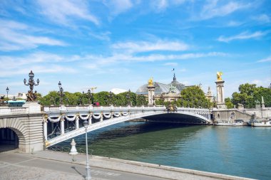 Köprü Alexandre III Seine Nehri kapsayan. Süslü Art Nouveau lambalar ve heykeller ile dekore edilmiştir. Paris. Fransa. Gün batımından önce mavi bulutlu gökyüzü