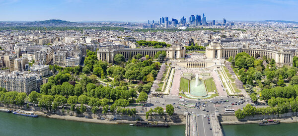 Aerial panoramic view of Paris, Trocadero with Chaillot Palace fountains and gardens and La defense contemporary business center skyscrapers at background horizon