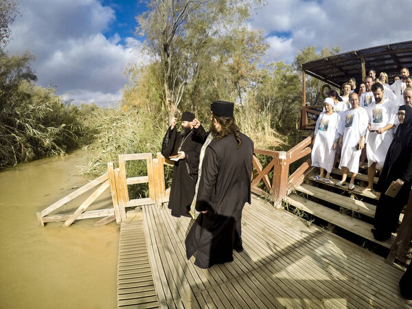 YERICHO, ISRAEL - 20 FEB, 2017: People are waiting to be baptized by water during a baptism ritual at Qasr el Yahud near Yericho on the Jordan river