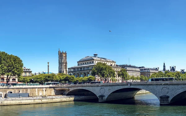 Seine river in Paris with Change bridge and tower of Saint-Jacques and the upper part of the fountain du Palmiere, Place Chatelet, Paris, France