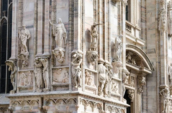 Milan cathedral gothic facade ornaments spire pointed arches statues marble