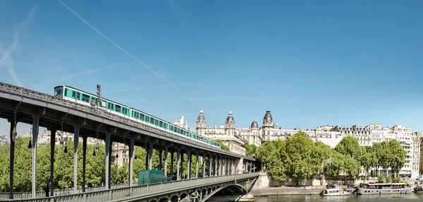 Bir-hakeim bridge metro line passing over seine river in sunny day in Paris city, panoramic view