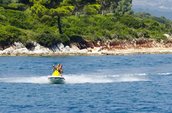 Father and daughter riding on jet ski