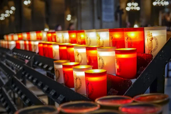 White and red votive candles in the church in the Notre-Dame Cathedral in Paris