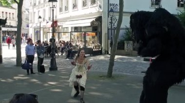 Couple doing some balet performance moves in front a street crowd at Monmartre in Paris. Its popular form of earnings in big cities. Beauty and beast in Slow Motion