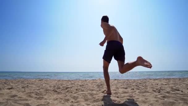 Manlig Löpning Och Hoppning Havsvatten Filmisk Steadicam Trekking Skott Slow — Stockvideo