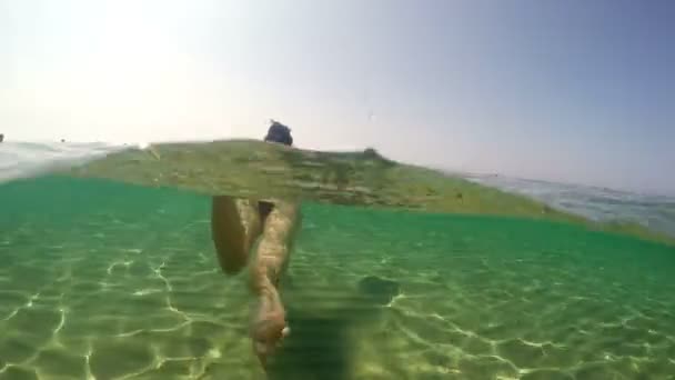 在绿石海水中游泳的妇女的水下角徒步 — 图库视频影像