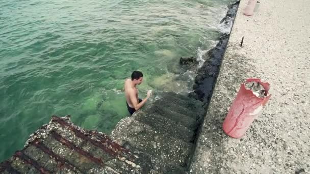 英俊的运动适合男孩出来的海水在港口楼梯上 — 图库视频影像