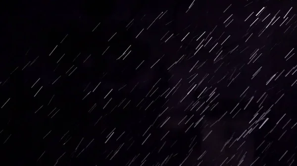 Heavy rain at night. Abstract background loop. It can be used as luma matte for video production