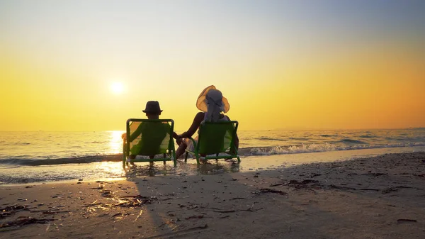 Mother Son Hat Sitting Beach Chairs Looking Setting Sun Splashed — Stock Photo, Image