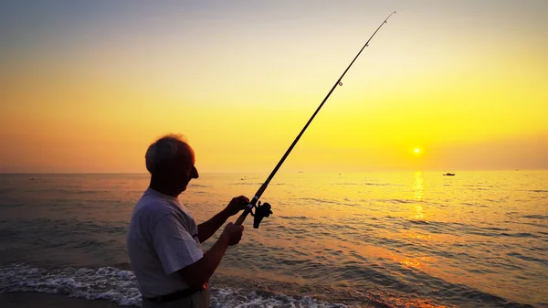 Silhouette Eines Aktiven Fischers Der Angeln Bei Sonnenuntergang Wirft — Stockfoto