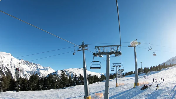 Mountains landscape pov with ski slopes and ski lifts on sunny day at mountain summit Todorka in Bansko world cup ski resort in Bulgaria