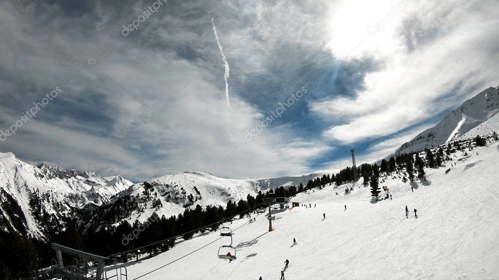 Aerial ski lift pov. Skiing at Pirin at the slope in Bansko resort, Bulgaria, slow motion