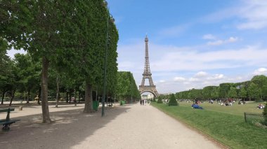 Paris, Fransa - 11 Mayıs 2017: Eyfel Kulesi Tour Eiffel Champs de Mars bahar ağaçları ve turist rahatlatıcı çimen'ın bahçesinde Paris, Fransa