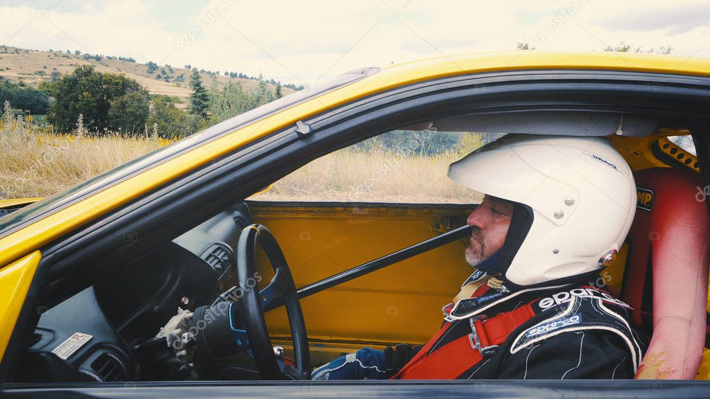 Kocani, Macedonia - 24 Jun, 2018: Sport driver sit at custom car during hillclimb race