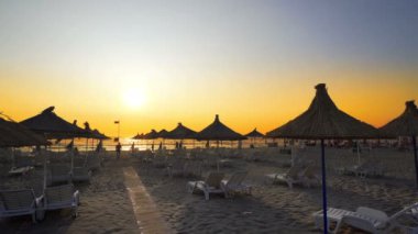 Gün batımına karşı güneş gözlüklü ve güneşli plaj, seyahat kavramı arka planı 