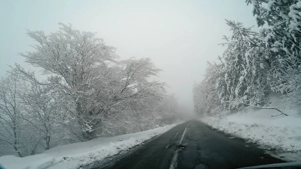 冬季驾驶波夫在雪暴风雪与恶劣的能见度在山的农村路 — 图库照片