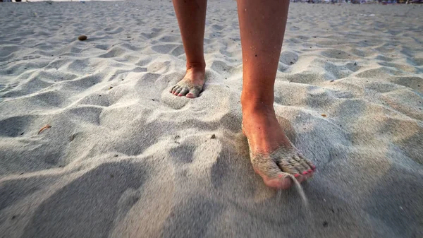 Barefoot woman feet walk on beach sand, cinematic steadicam shot. Summer vacation holiday