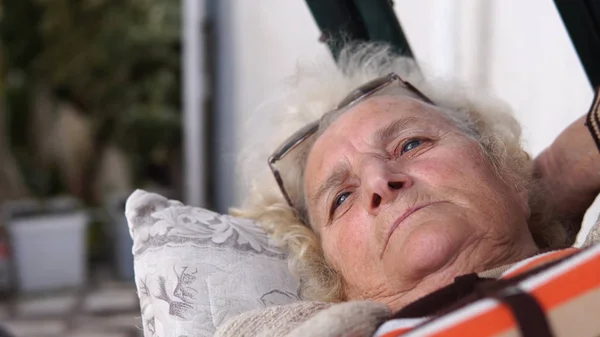 Portrait Beautiful Talking Elderly Woman Lying Outdoors Porch Swing Thinking — Stock Photo, Image