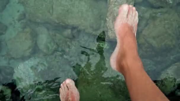 Man Relaxes Sea Sitting Edge Pier Swing Feet Water Surface — Stock Video