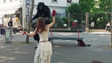 Couple doing some balet performance moves in front a street crowd at Monmartre in Paris. Its popular form of earnings in big cities. Beauty and beast in Slow Motion
