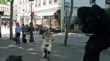 Couple doing some balet performance moves in front a street crowd at Monmartre in Paris. Its popular form of earnings in big cities. Beauty and beast in Slow Motion