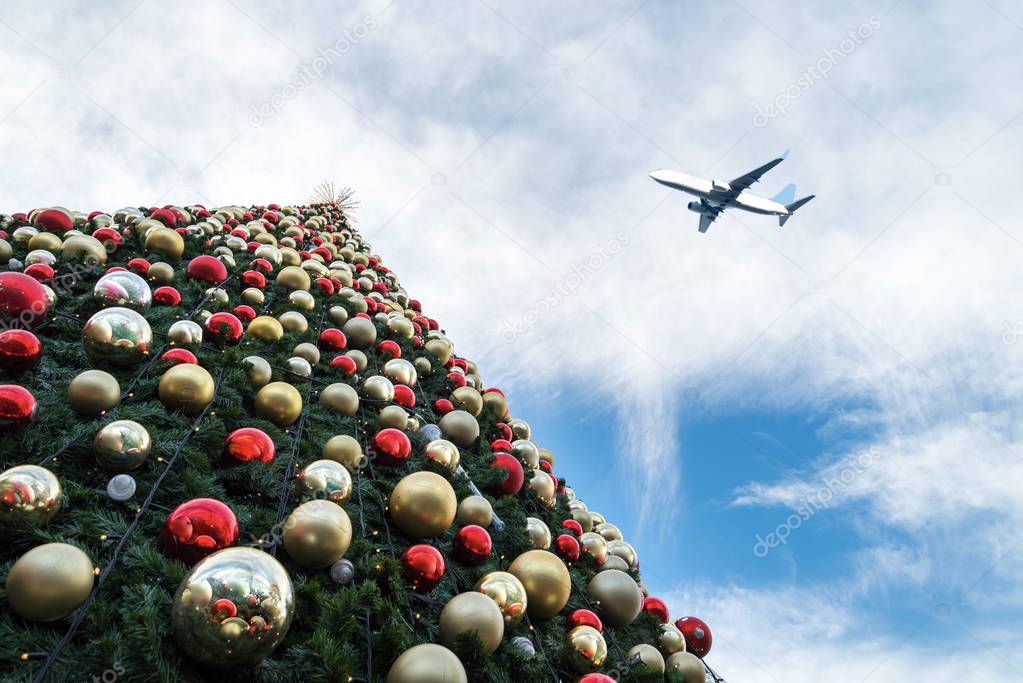 Decorated Christmas tree and airplane in  blue sky
