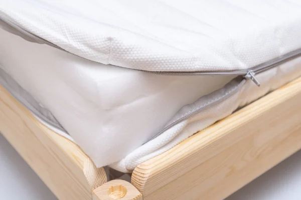 Inside of foam mattress on wooden bed