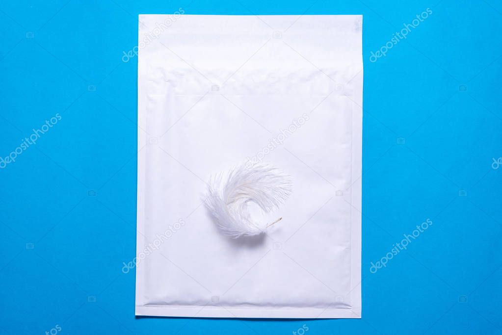 Lightweight bubble envelope with feather on blue background