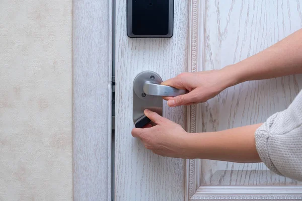 Woman closes door lock deadbolt — Stock Photo, Image