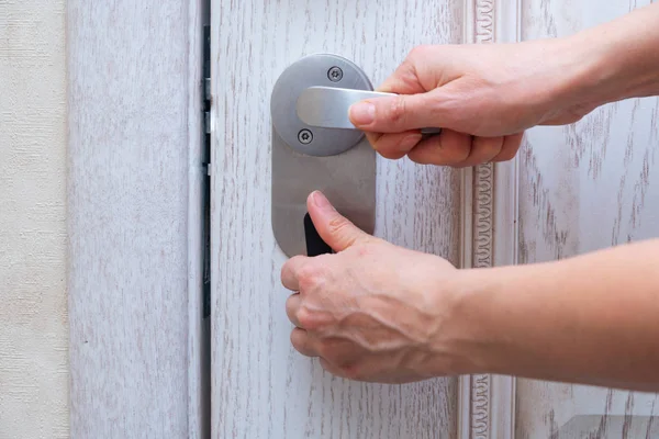 Woman closes door lock deadbolt — Stock Photo, Image