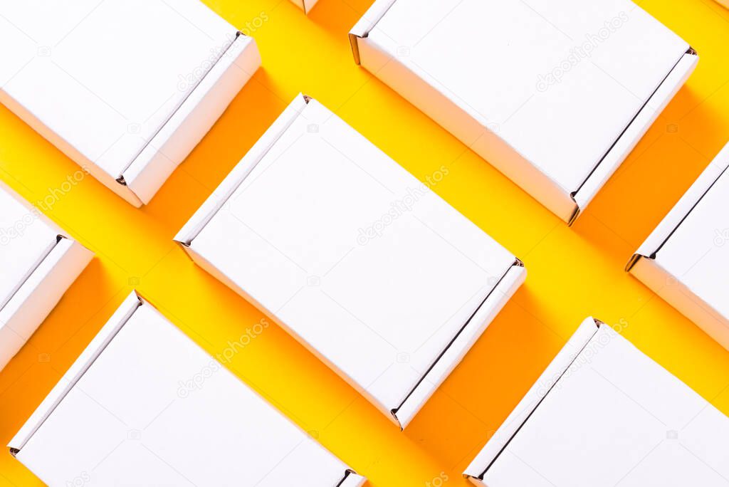 Lot of square carton boxes on yellow background