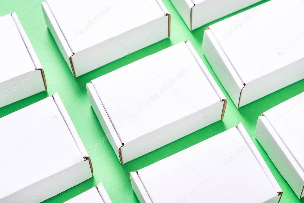 Lot of square carton boxes on green background