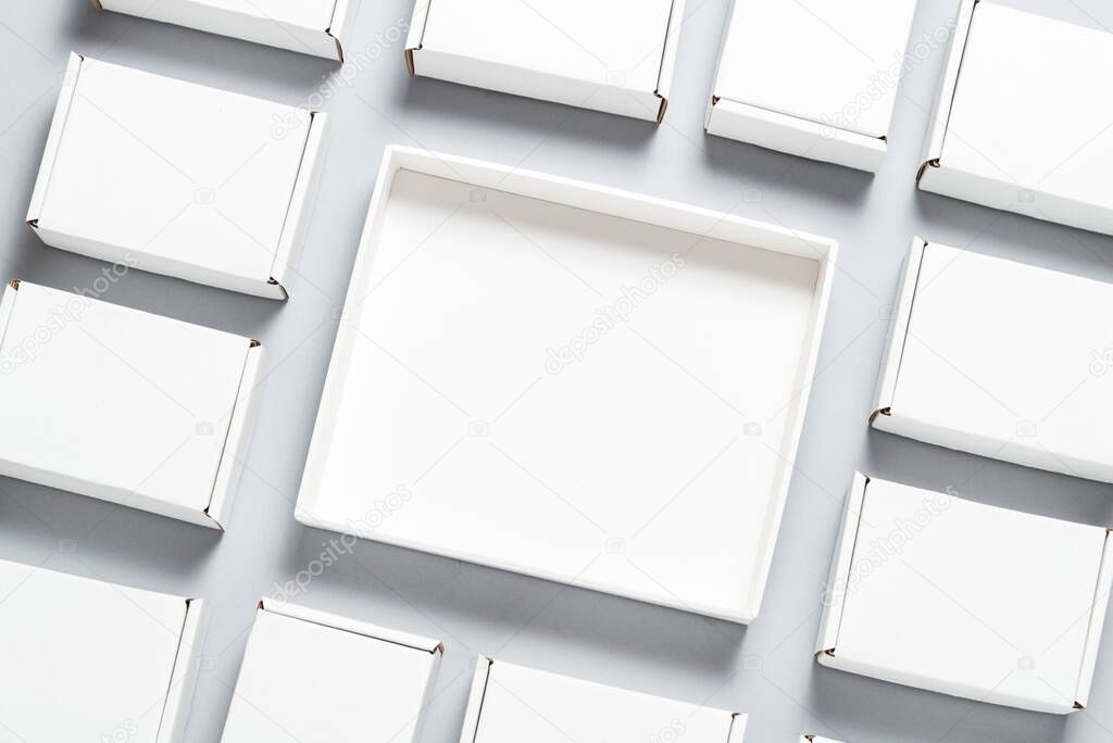 Lot of square carton boxes on grey background